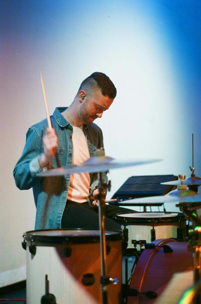 Drummer in action performing live