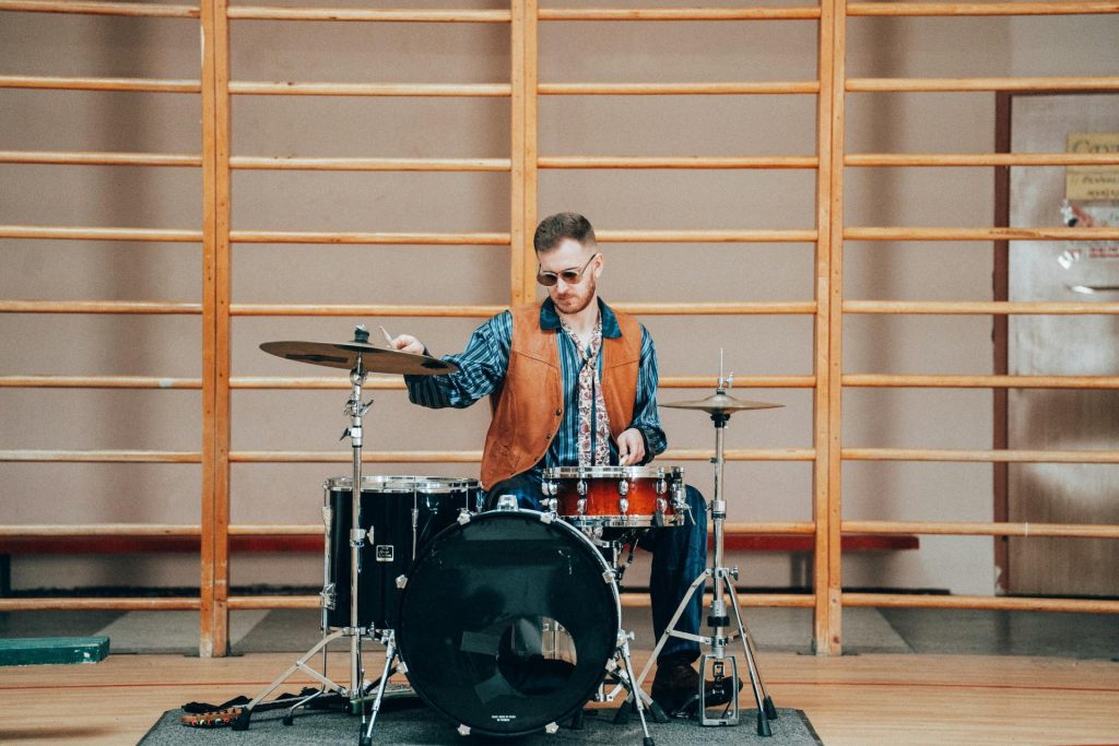 Drummer in shades playing drums